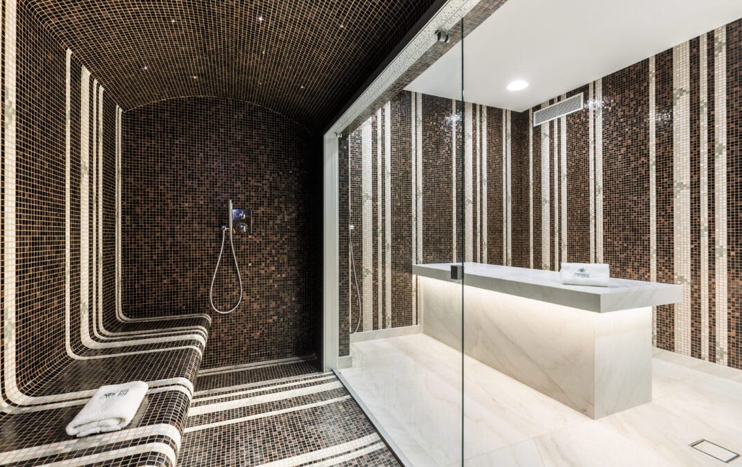Hammam en mosaïque et douche vitrée au spa du Château de Berne